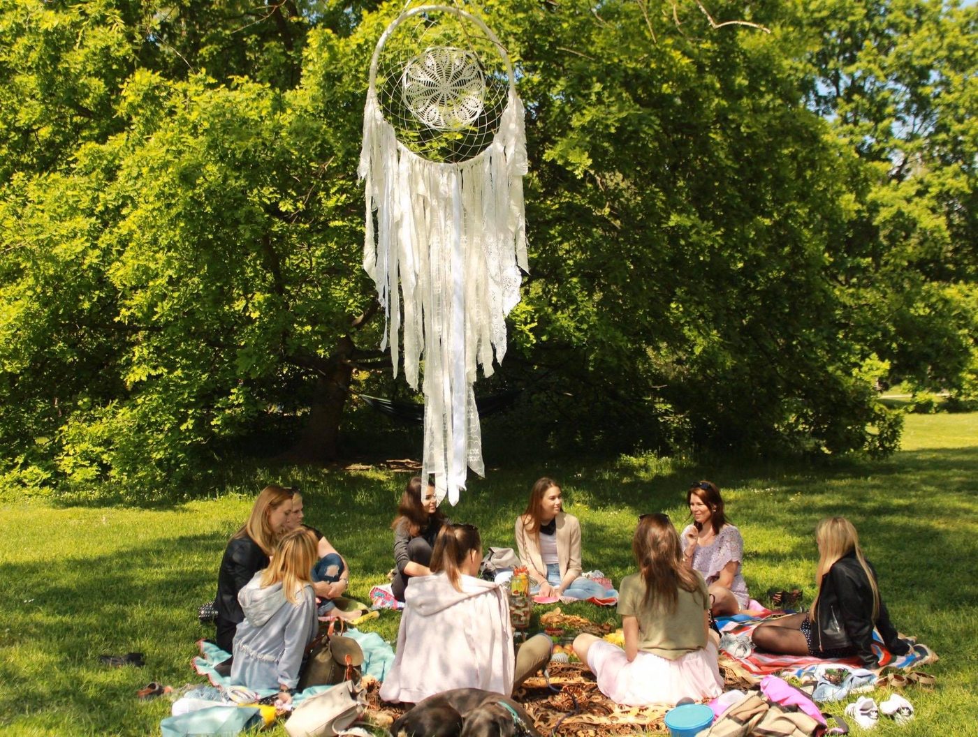 Group tarot reading circle in a Prague park